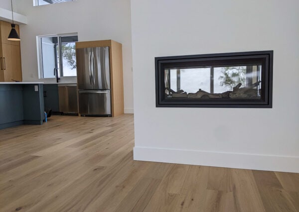Fireplace dividing living and dining areas