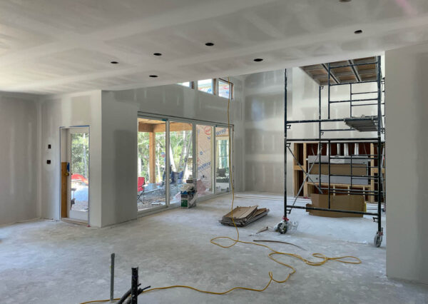 Under construction home with windows, drywall progress