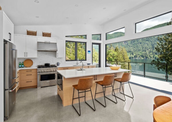 Custom home Kitchen with large door opening on to lakefront