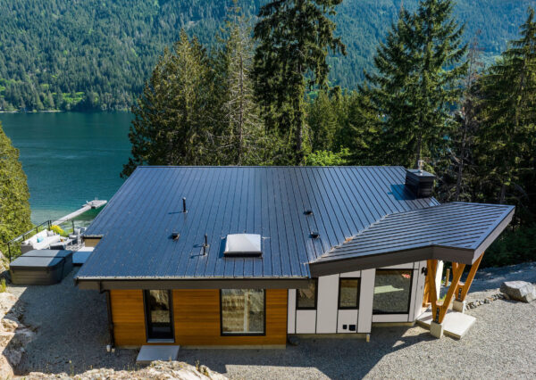 Metal roof on lakefront custom home with wood siding