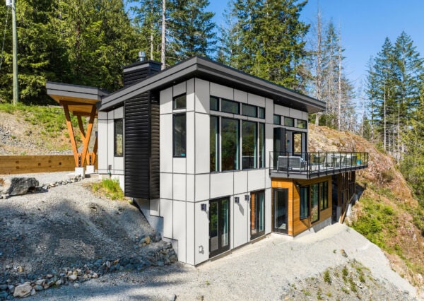 Custom home with wood details and black metal siding and trims