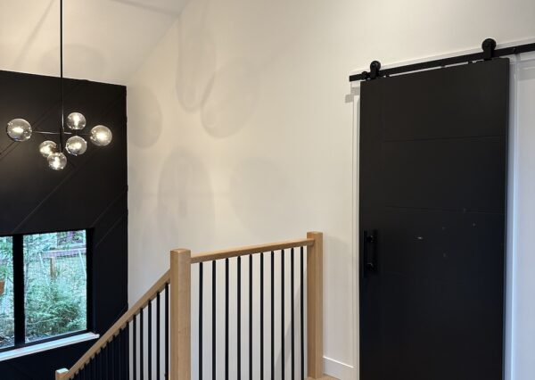 Custom staircase with metal and wood railings and wood treads