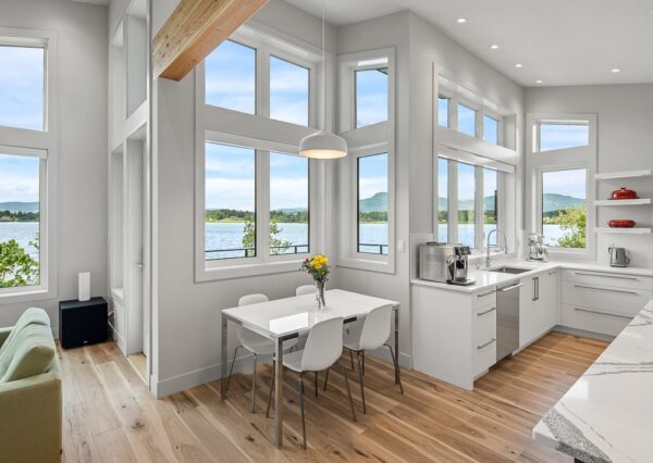 Custom kitchen design with tall ceilings, wood beams and large windows