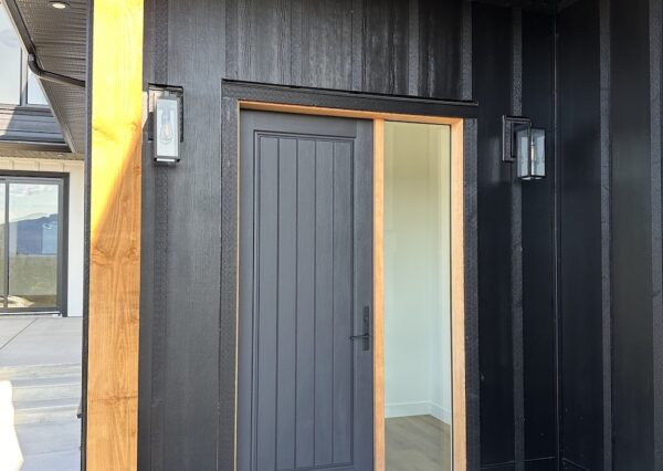 Black front door entrance to custom home in Shawnigan