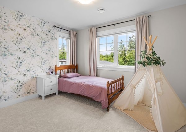 Girls bedroom with wallpaper and carpet