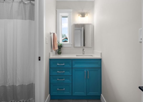 Blue vanity in kids bathroom of custom home