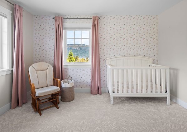 Nursery with wallpaper and ocean view in new home build
