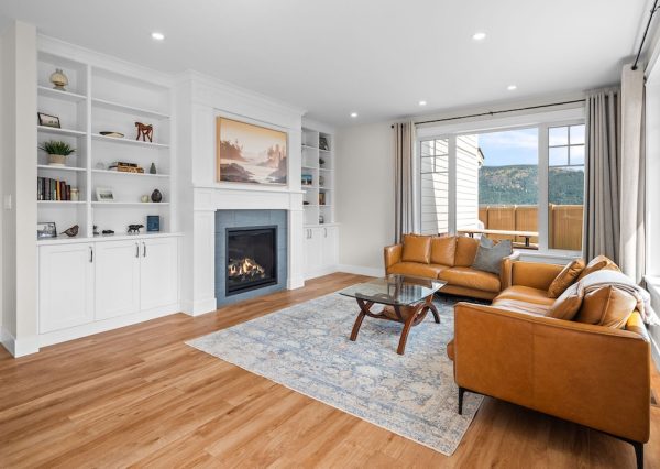 Living room with built in cabinetry around fireplace and mountain views
