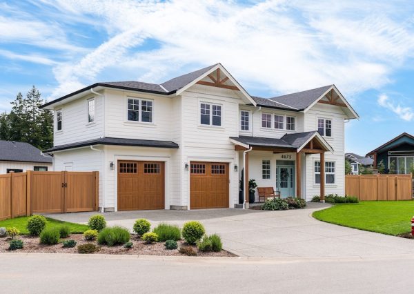 White hardie plank with wood features on custom home exterior