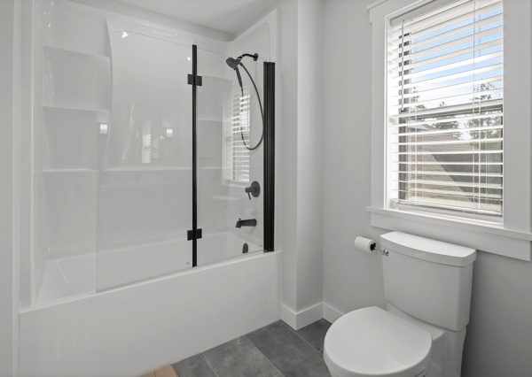 Guest bathroom with built in bathtub with custom glass