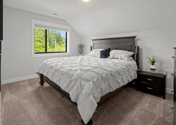 Guest room with slanted ceiling and carpeted floors