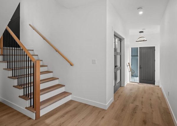 Front entrance with wood floors and black front door.