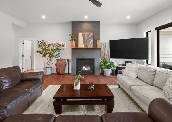 Living room in open concept home with gas fireplace