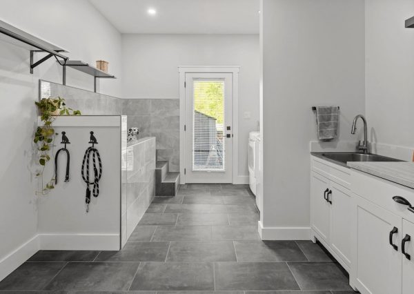 Mudroom with laundry, sink and dog shower with tiled floors