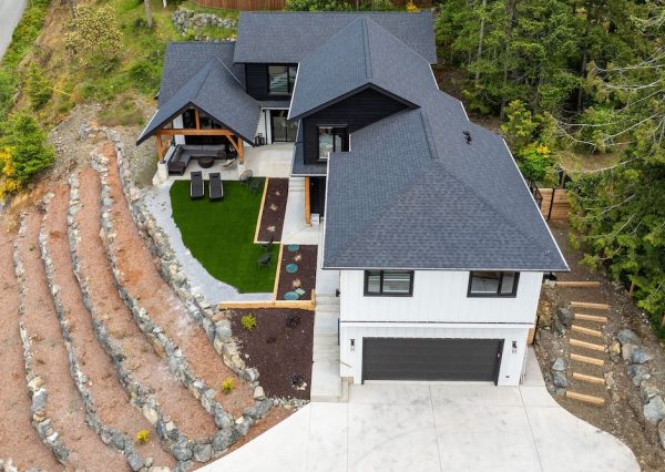 Black and white board and batten exterior on custom home with wood features