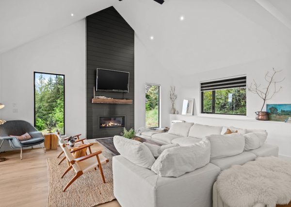 Open concept living room with gas fireplace and wood floors