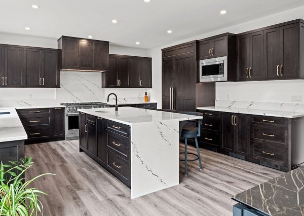 Large u-shaped kitchen with cabinet front fridge