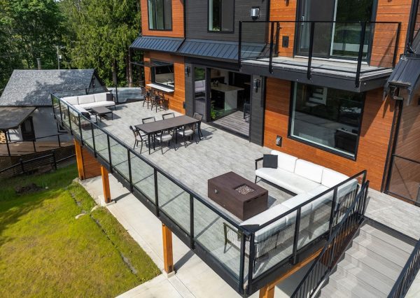 Large outdoor entertaining space with large sliding patio doors and pass through window from kitchen