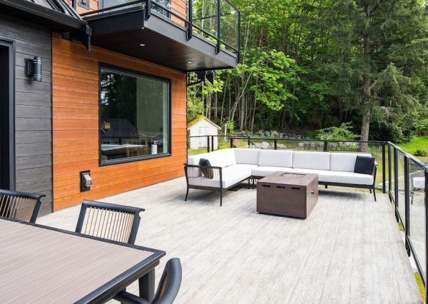 Large deck with vinyl decking and glass rails