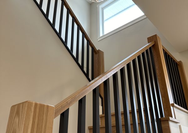 Custom wood staircase in modern farmhouse home with modern lighting