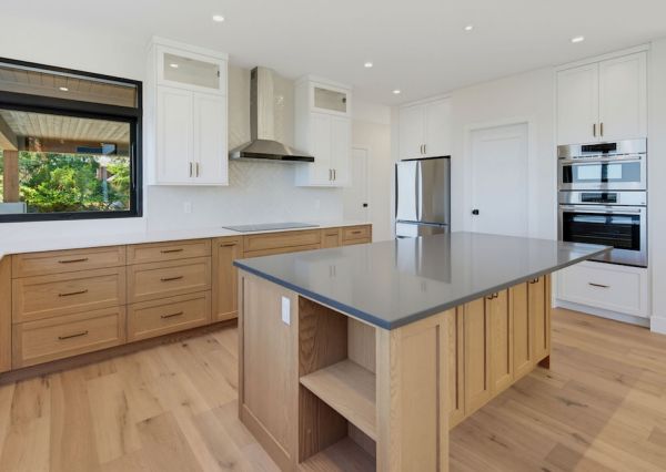 Custom wood and white kitchen cabinetry with large centre island